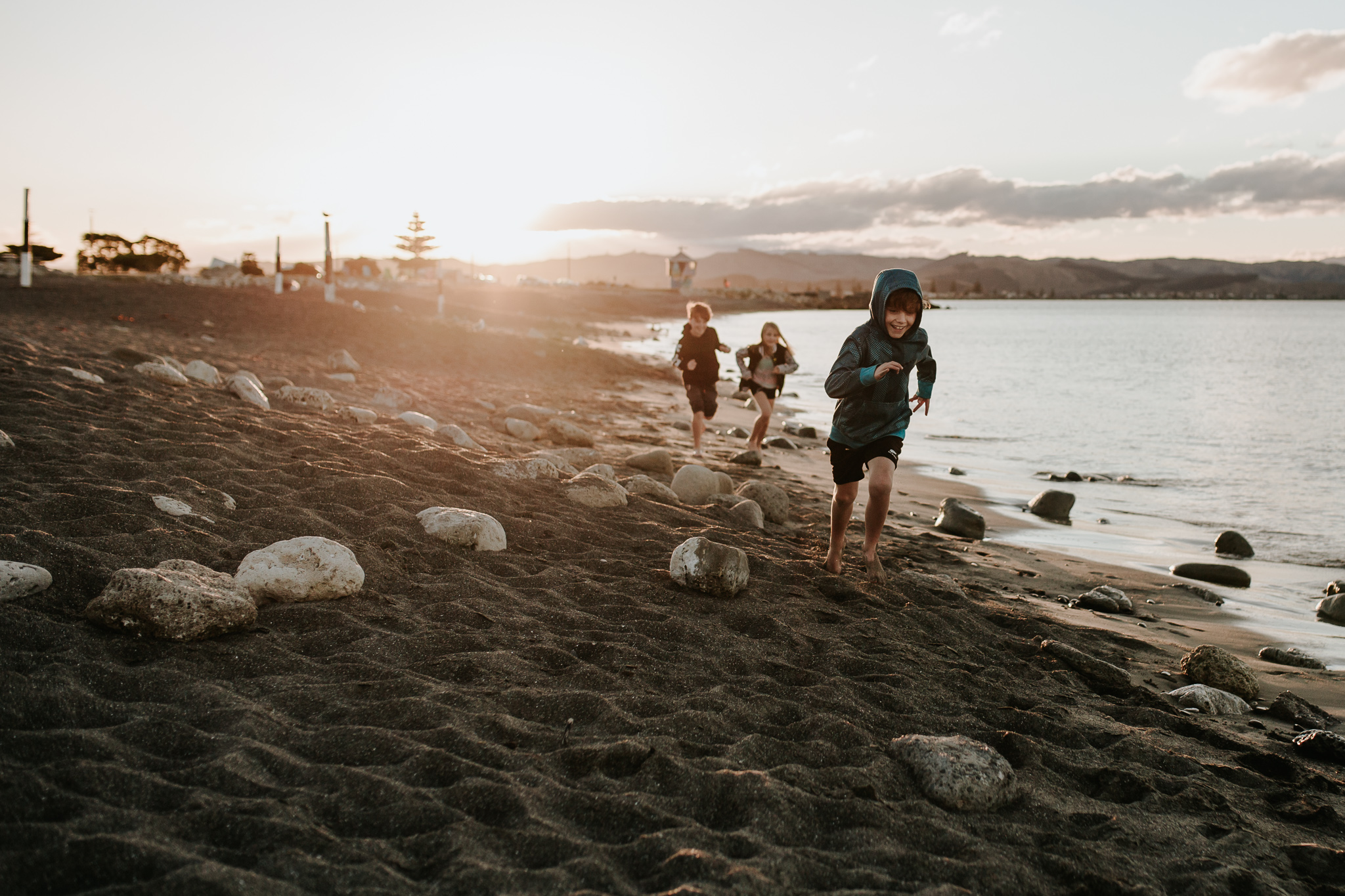 kids running beach sunset
