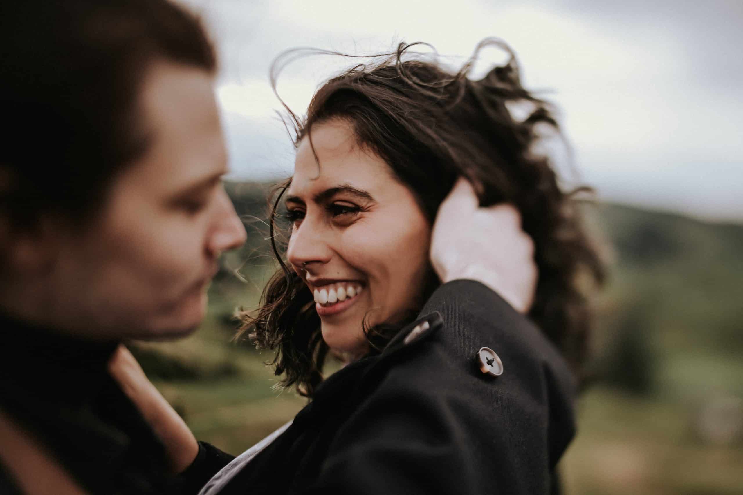 engagement shoot couple smile windy