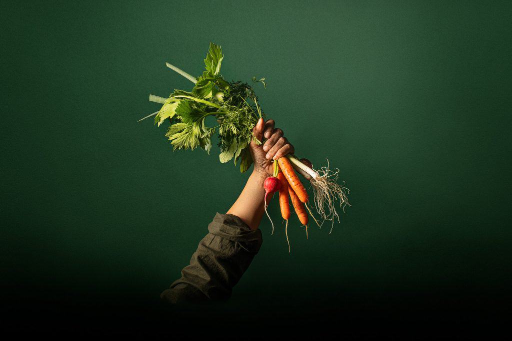 Amber Jayne Bain hand holding carrots and vegetables
